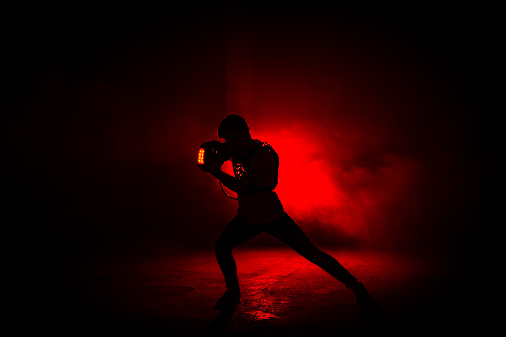 Individual laser tag player illuminated in red
