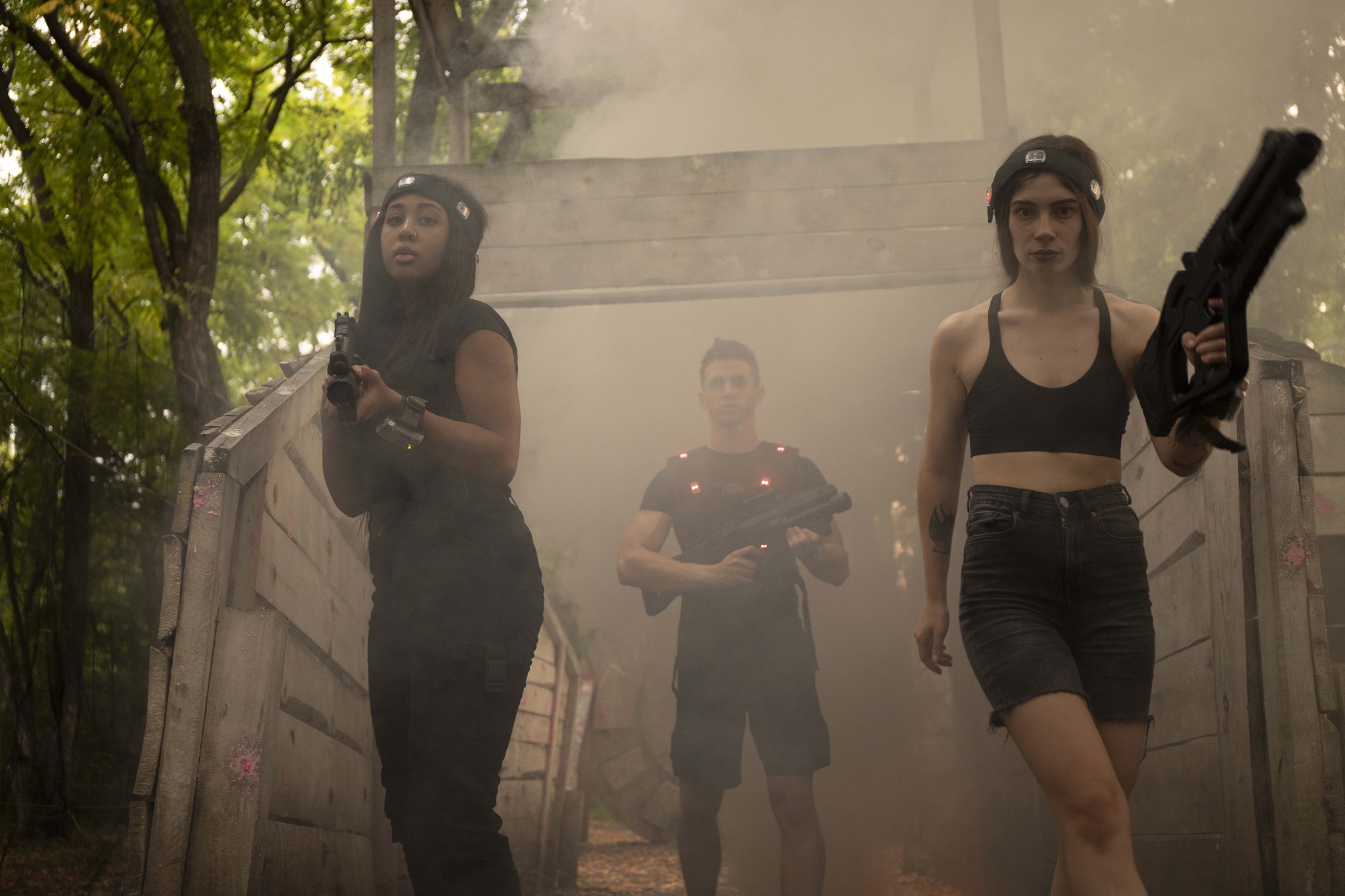 Laser tag players advancing together through smoke